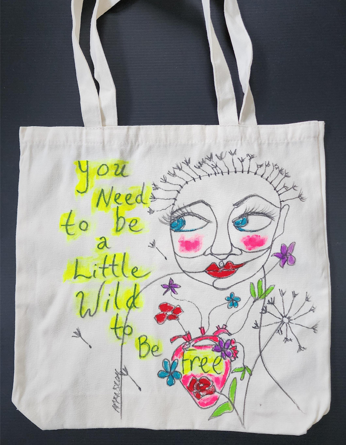 Shop - You Need to Be a Little Wild to Be Free, Black and White Tote Bag by April Mansilla.